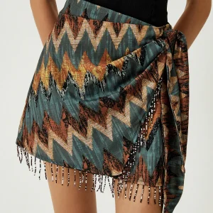 Mini-jupe nouée à ourlet à pompons imprimés